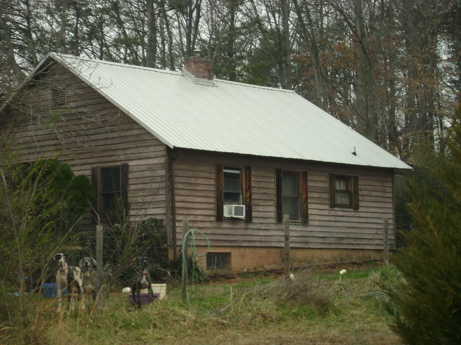 White metal roof on an old wood sided farmhouse, from a Metal Roof Installation job in Westerville